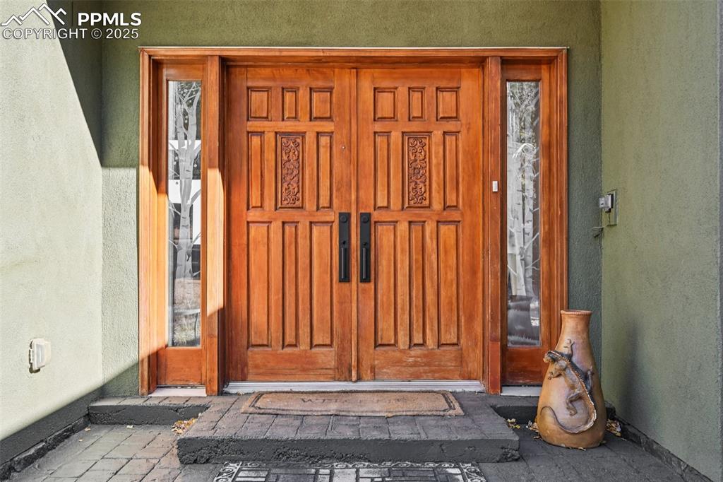 Image 3 of 50: Grand entry with custom wood doors