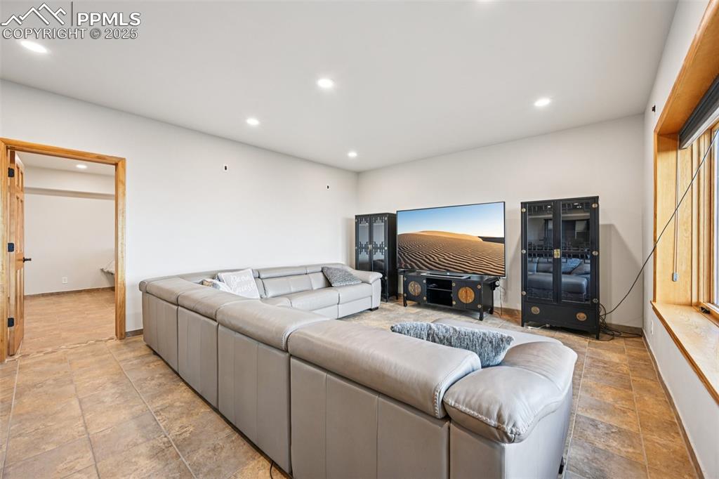 Image 39 of 50: Recreation room on the lower level with a walk out to covered back patio