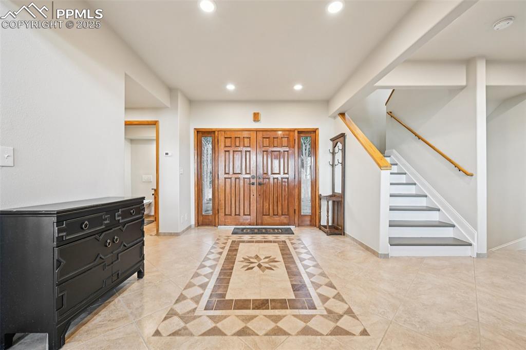 Image 4 of 50: Grand foyer with tile flooring bringing you into the open concept main leve