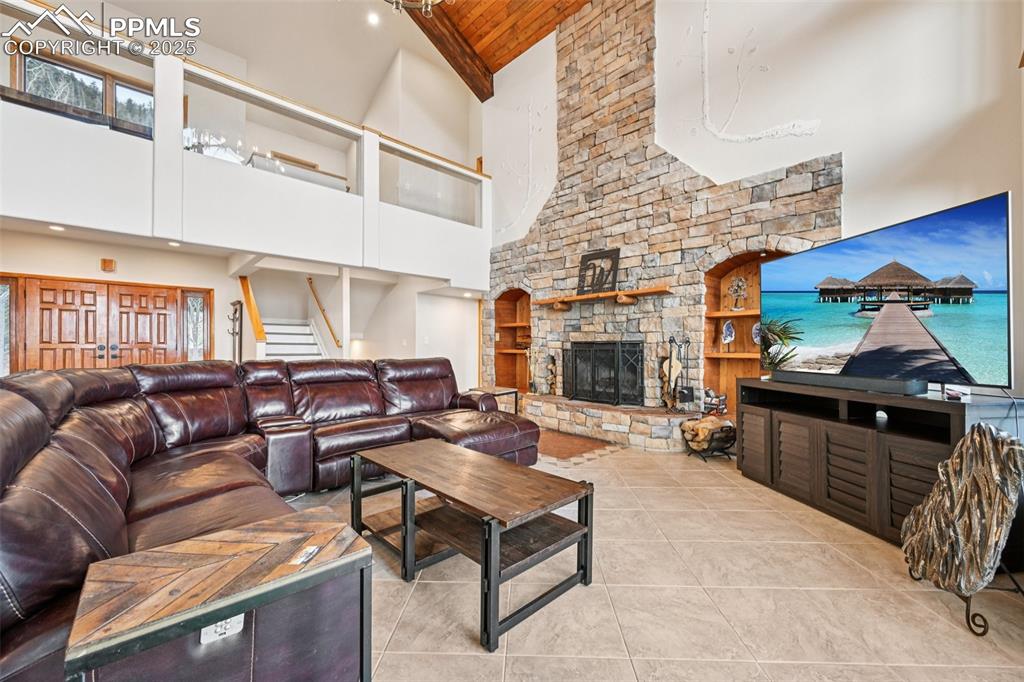 Image 5 of 50: Living room with walk and out wood burning fireplace all surrounded by 27 f