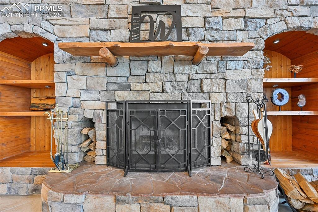 Image 6 of 50: Custom wood burning fireplace in living room