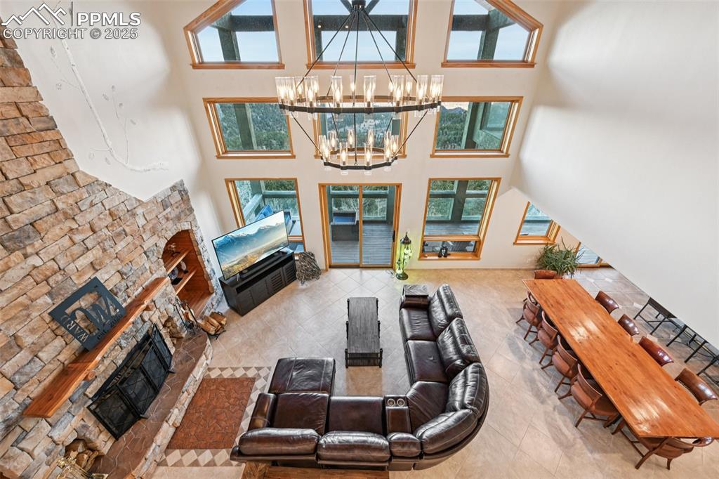 Image 7 of 50: Living room view from the upper level. Just look at the newer chandelier an