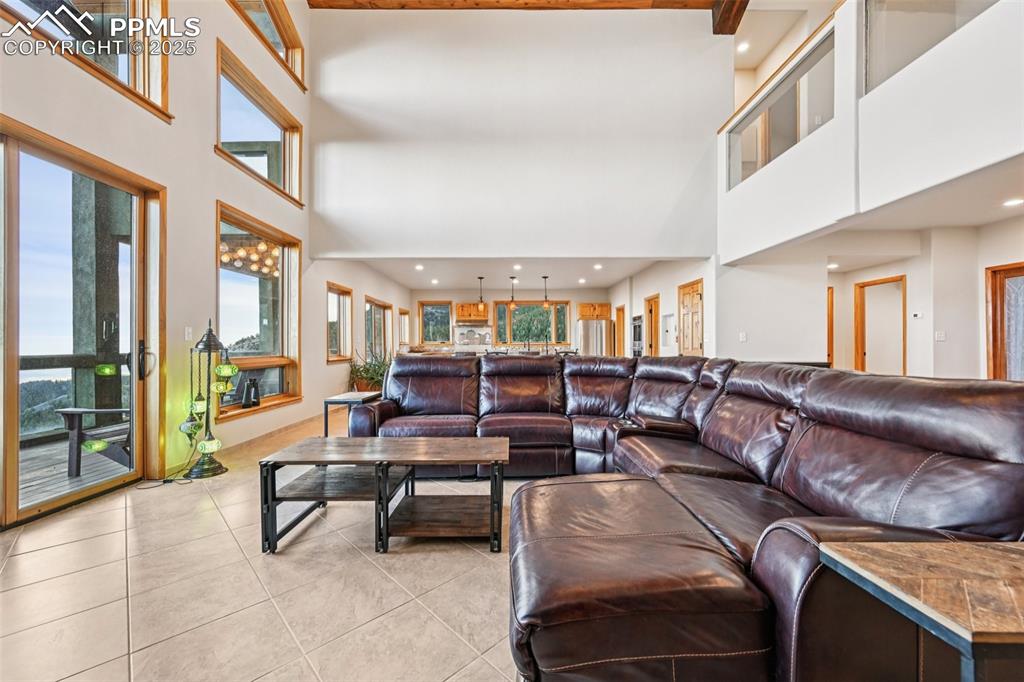 Image 8 of 50: Open concept living room with wall of windows bringing in natural light and