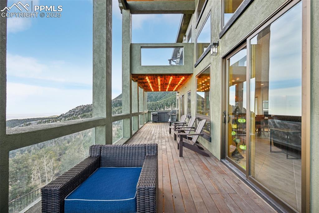 Image 9 of 50: Walk out to the covered back deck from the living room