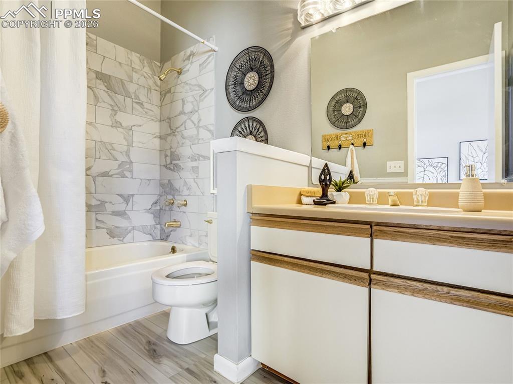 Image 10 of 50: The primary full bath features a tub/shower with newly finished tile surrou