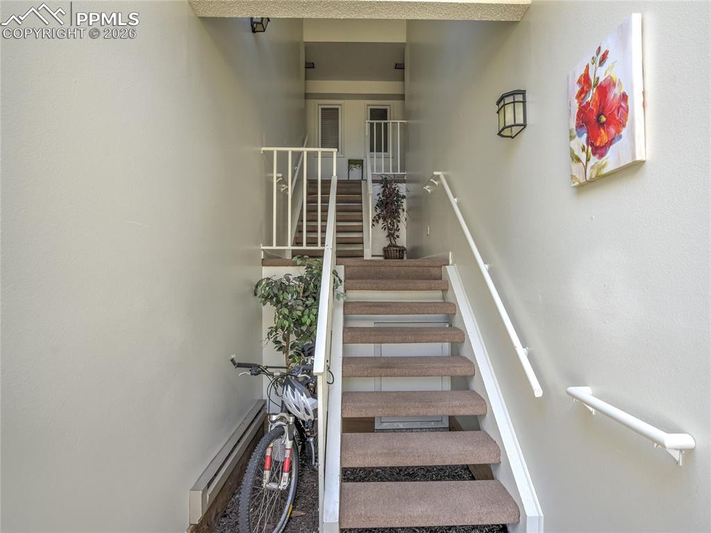 Image 13 of 50: The interior entry way inside the building provides access upstairs to the 
