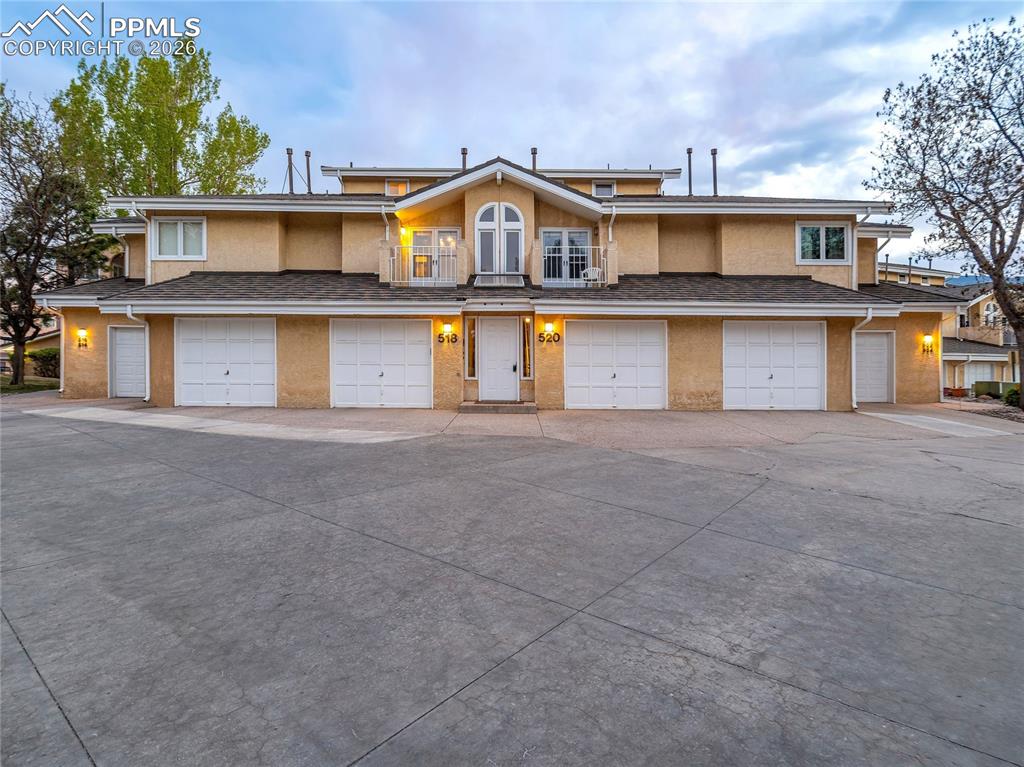 Image 2 of 50: The front of the property shows the building space, where a 2-car tandem ga
