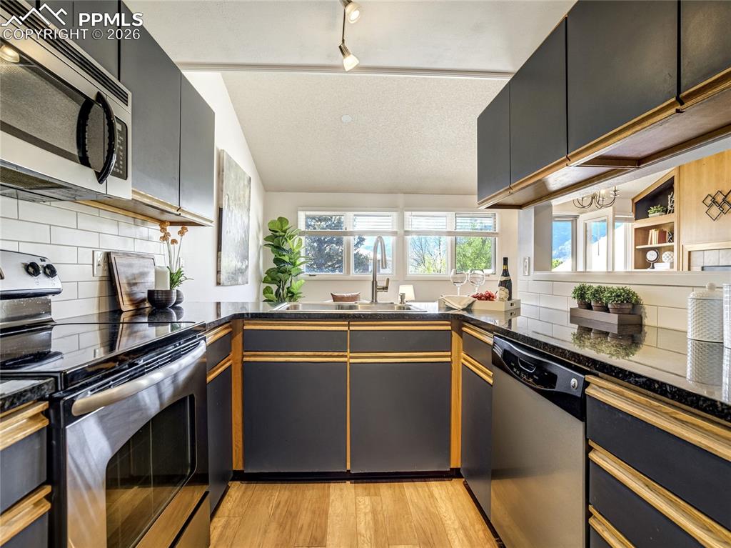 Image 6 of 50: A bright and functional kitchen seamlessly connects to the living and dinin
