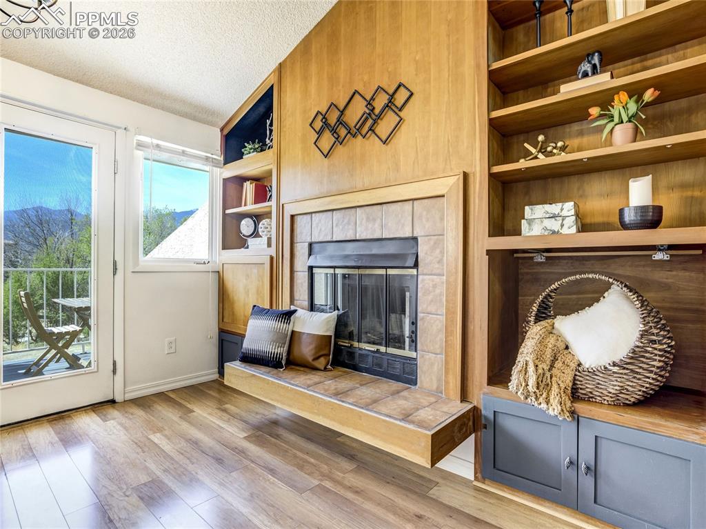 Image 7 of 50: The fireplace surround is authentic to the original build, and feels timele