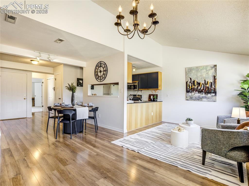 Image 8 of 50: A seamless blend of living, dining, and kitchen spaces create a bright and 