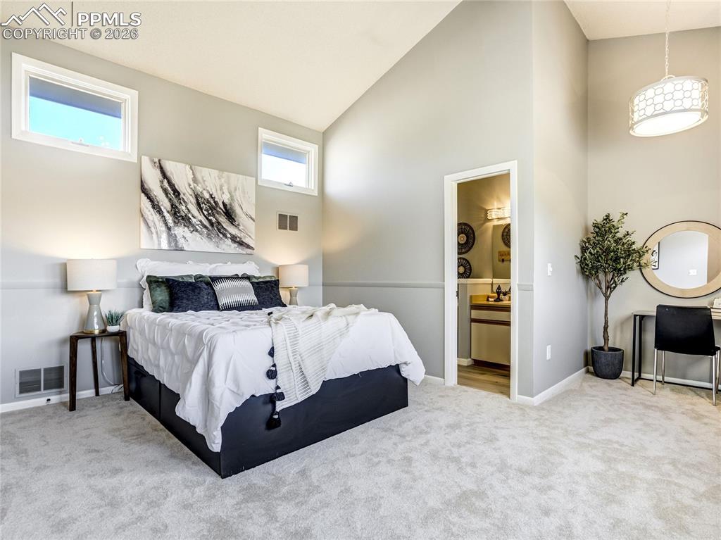 Image 9 of 50: Upper-level private primary retreat with vaulted ceilings, soft natural lig