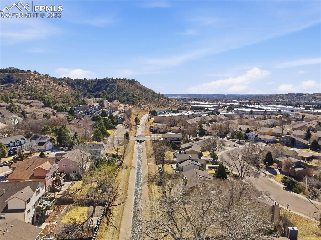 Image 12 of 50: Aerial perspective of suburban area featuring mountains
