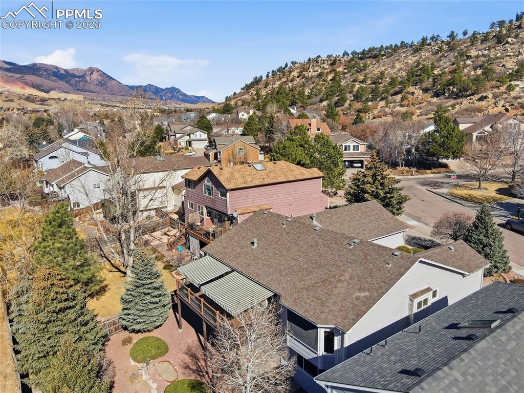 Image 14 of 50: Aerial view of residential area featuring a mountain backdrop