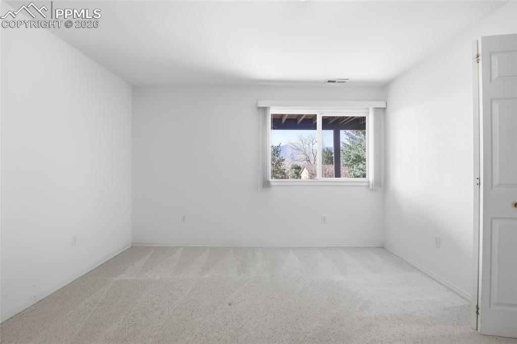 Image 45 of 50: Unfurnished room with light colored carpet and baseboards