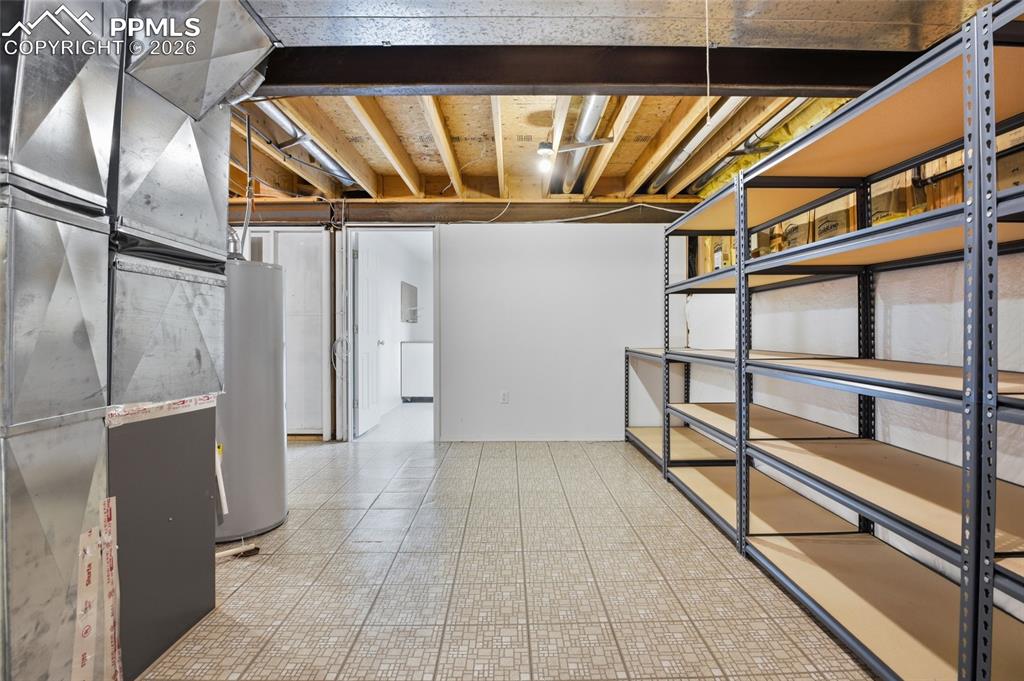 Image 50 of 50: Unfinished basement featuring water heater and heating unit