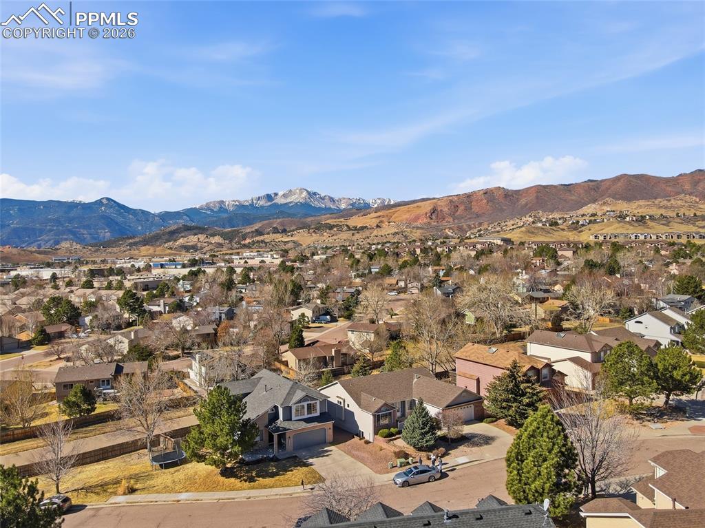 Image 9 of 50: Aerial view of residential area with a mountainous background