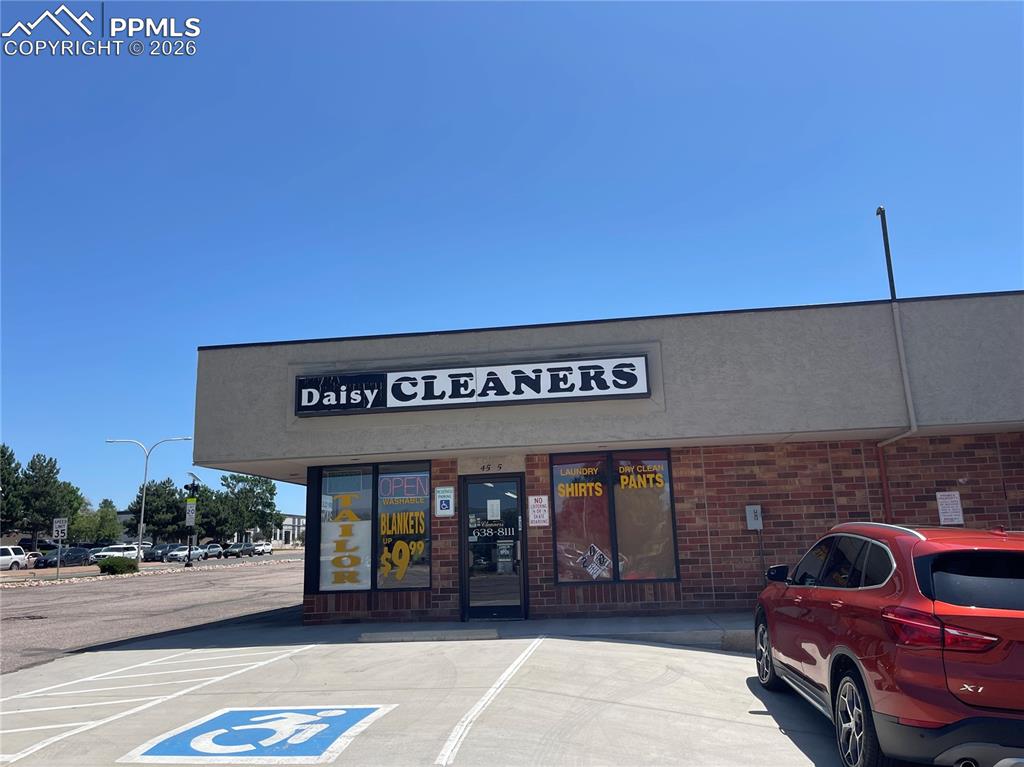 Caption: View of commercial property featuring uncovered parking