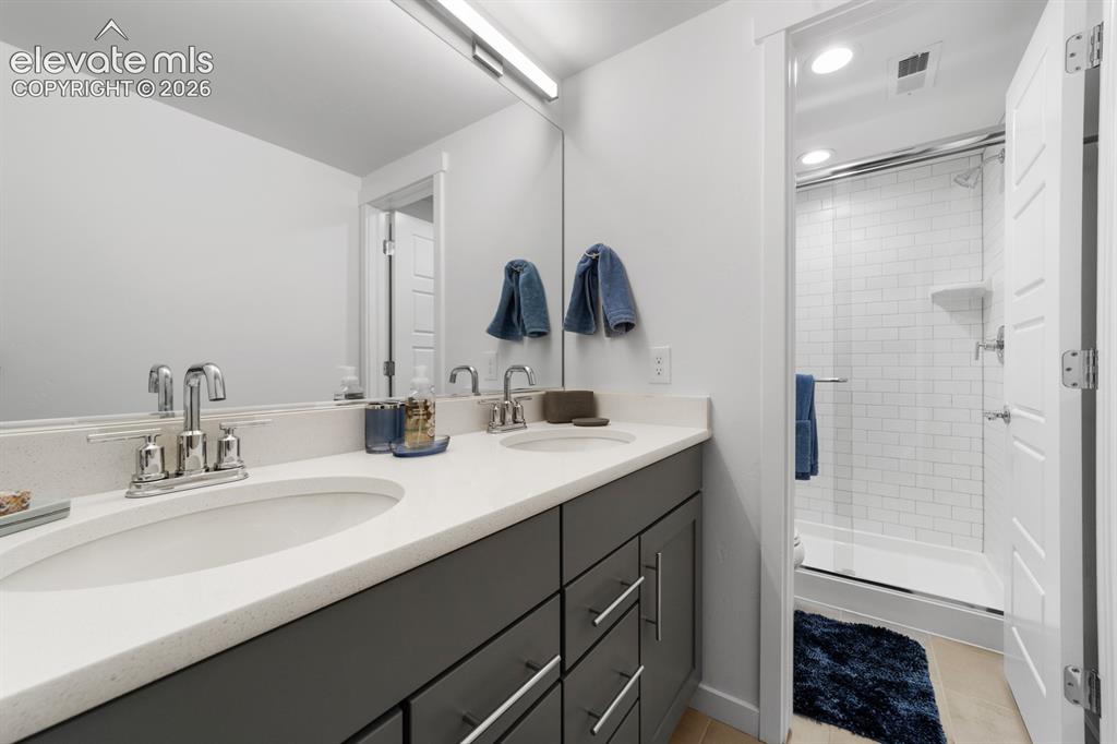 Image 32 of 38: Double vanity with undermount sinks and chrome fixtures