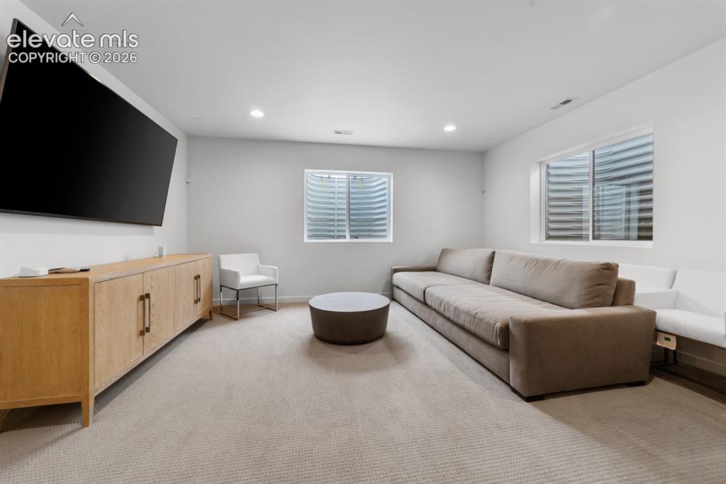 Image 36 of 38: Spacious recreation room featuring recessed lighting, light-toned carpeting