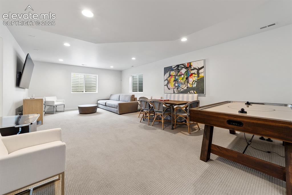 Image 37 of 38: Spacious interior room featuring light-toned carpeting, recessed lighting,