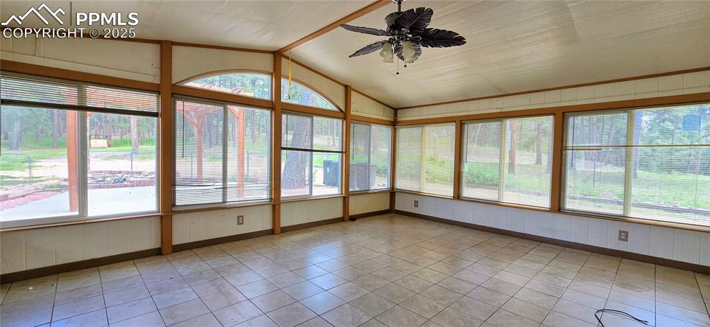 Image 15 of 48: Unfurnished sunroom featuring wooden walls