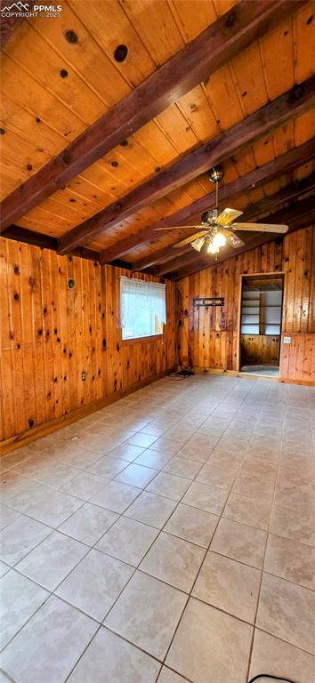 Image 18 of 48: Unfurnished living room with light tile patterned flooring, a wood ceiling 