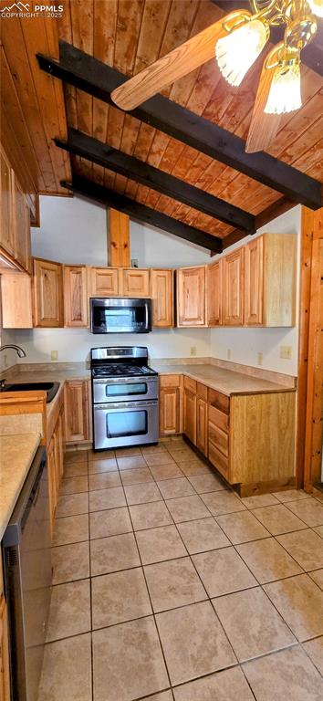 Image 22 of 48: Kitchen featuring wood ceiling, light tile patterned flooring, stainless st