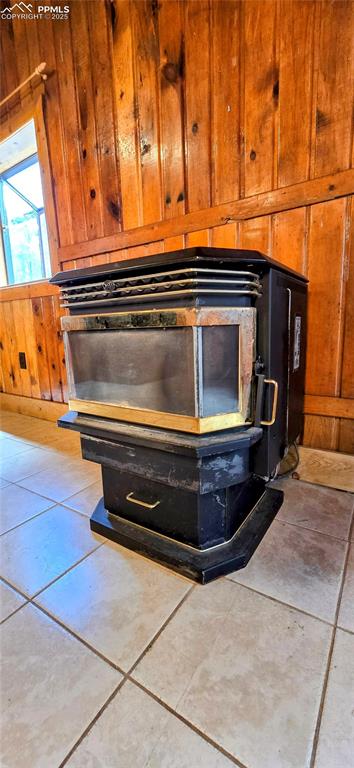 Image 24 of 48: Detailed view of wooden walls and a wood stove