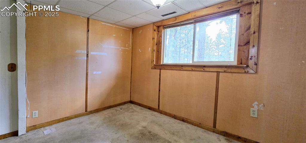 Image 26 of 48: Unfurnished room with baseboards and a drop ceiling