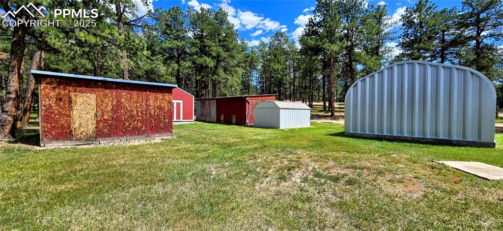 Image 27 of 48: View of green lawn featuring a shed