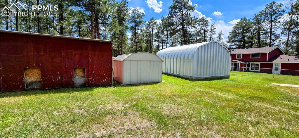 Image 3 of 48: View of green lawn featuring a storage unit