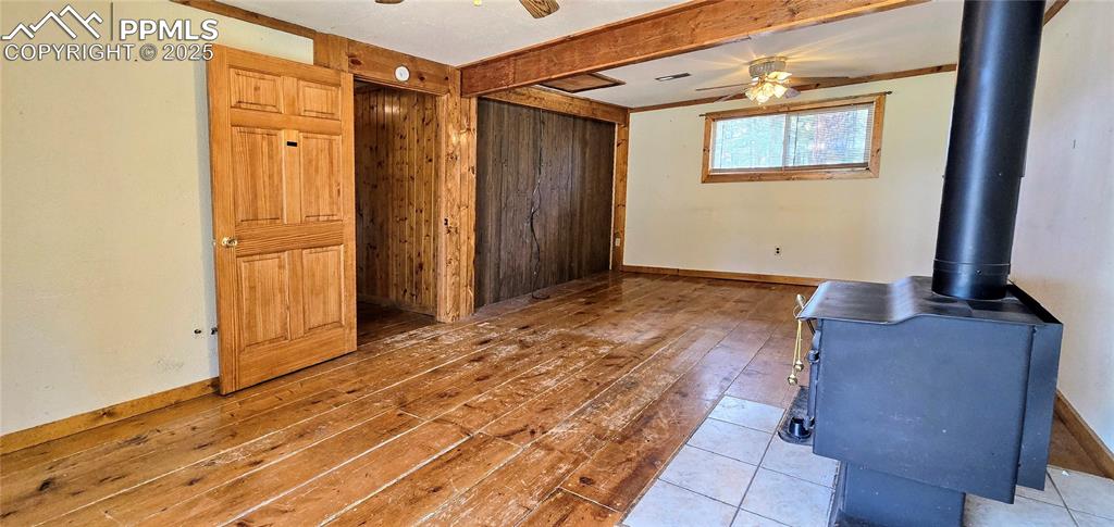 Image 43 of 48: Unfurnished living room featuring ceiling fan, hardwood / wood-style floori