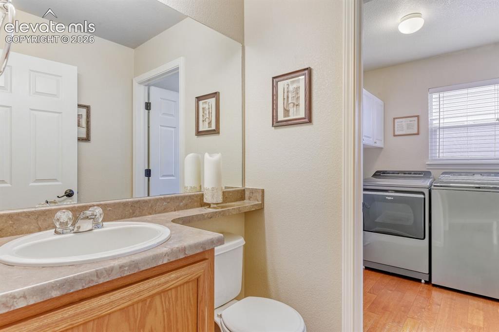 Image 12 of 28: Main level half bath with laundry.