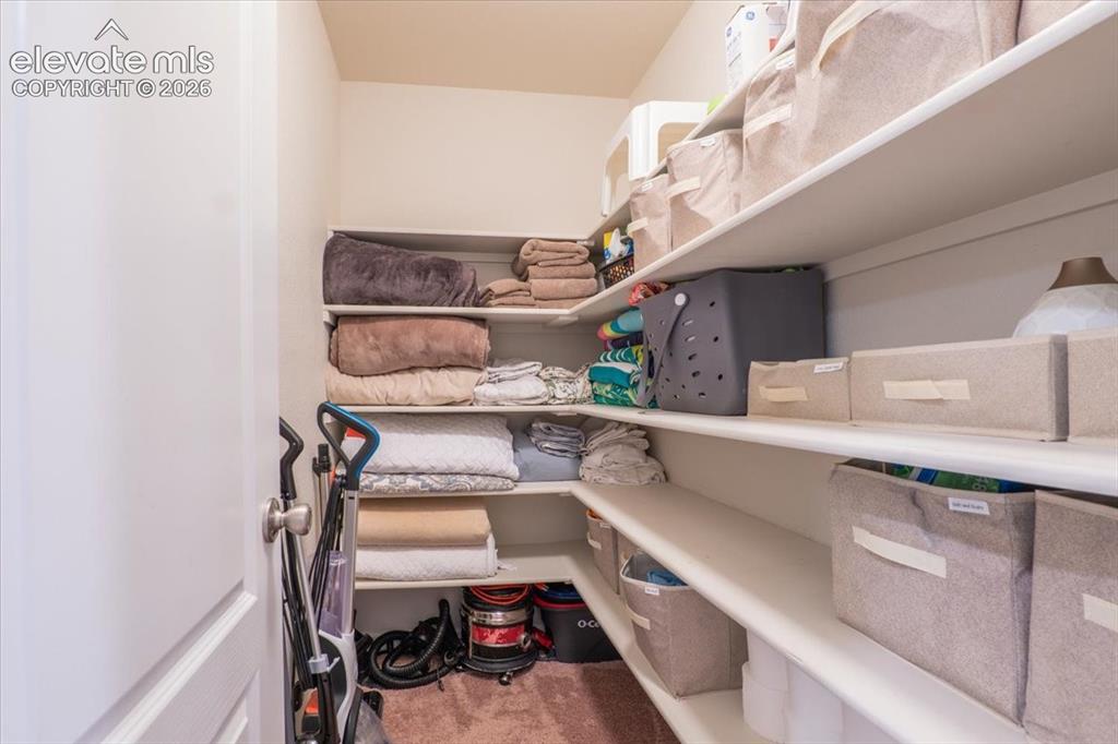 Image 32 of 50: Upstairs hallway linen closet where your vacuum can live