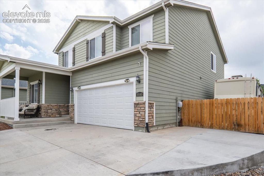 Image 6 of 50: Concrete driveway extends to the back, room for 9 cars 
