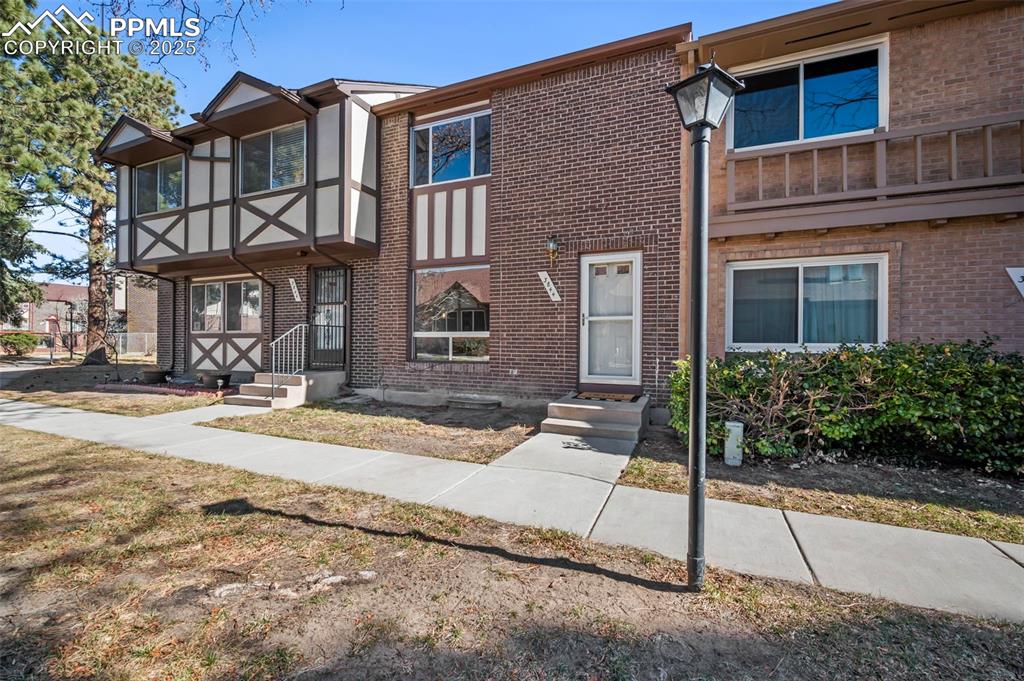 Caption: View of front of property featuring brick siding