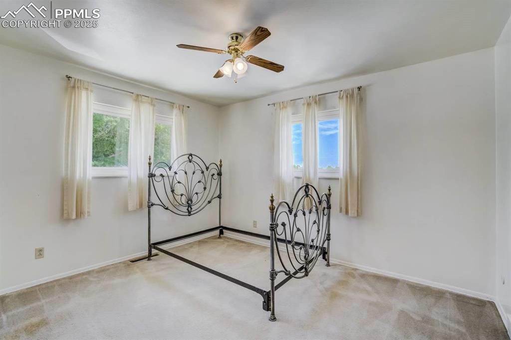 Image 17 of 37: Bedroom featuring light colored carpet and a ceiling fan
