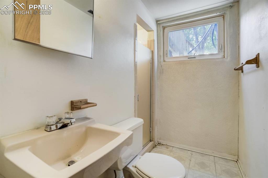 Image 23 of 37: Bathroom featuring toilet and a shower with shower door