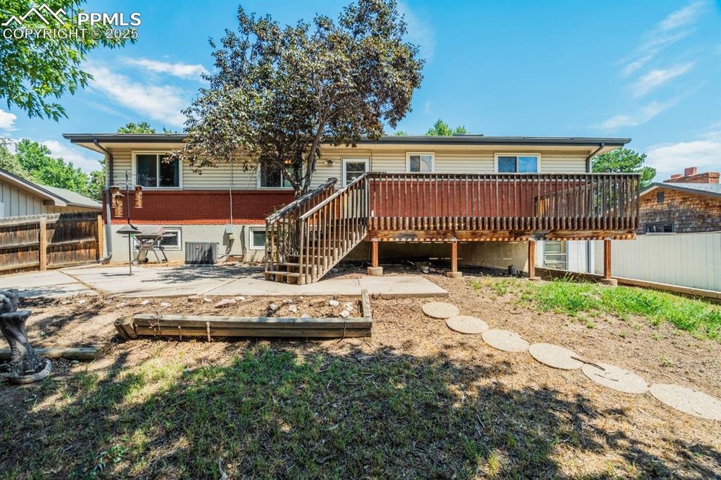 Image 28 of 37: Rear view of house featuring a fenced backyard, a patio area, a wooden deck