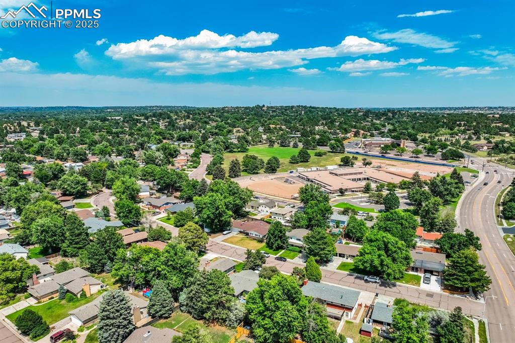 Image 33 of 37: Aerial perspective of suburban area with a tree filled landscape