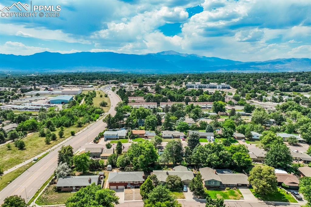 Image 36 of 37: Aerial view of residential area featuring mountains