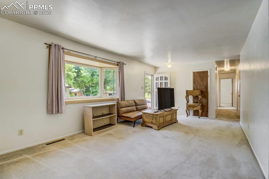 Image 6 of 37: Living area featuring light colored carpet