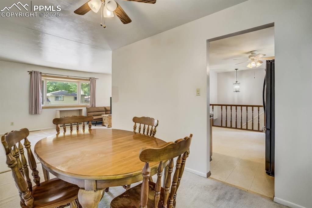 Image 8 of 37: Dining area with ceiling fan and light colored carpet
