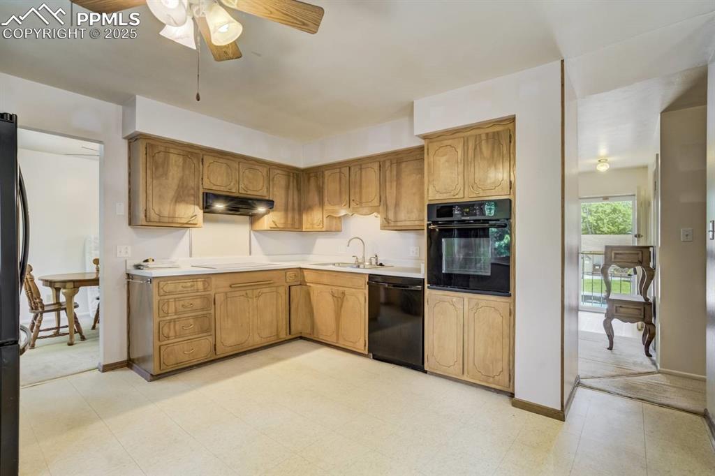 Image 9 of 37: Kitchen featuring light flooring, black appliances, light countertops, and 