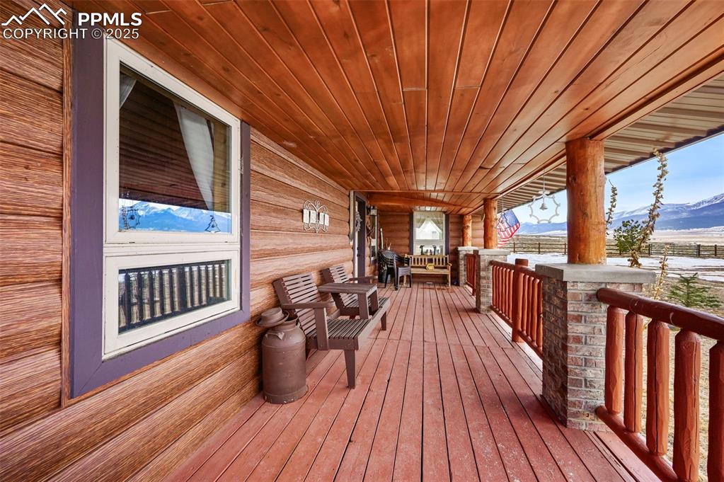Image 14 of 50: Deck featuring a mountain view and a porch