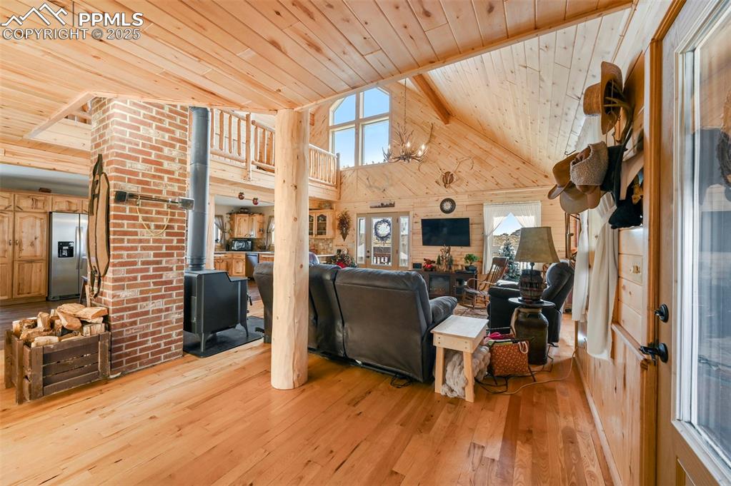 Image 17 of 50: Living room with high vaulted ceiling, beam ceiling, wood ceiling, a wood s
