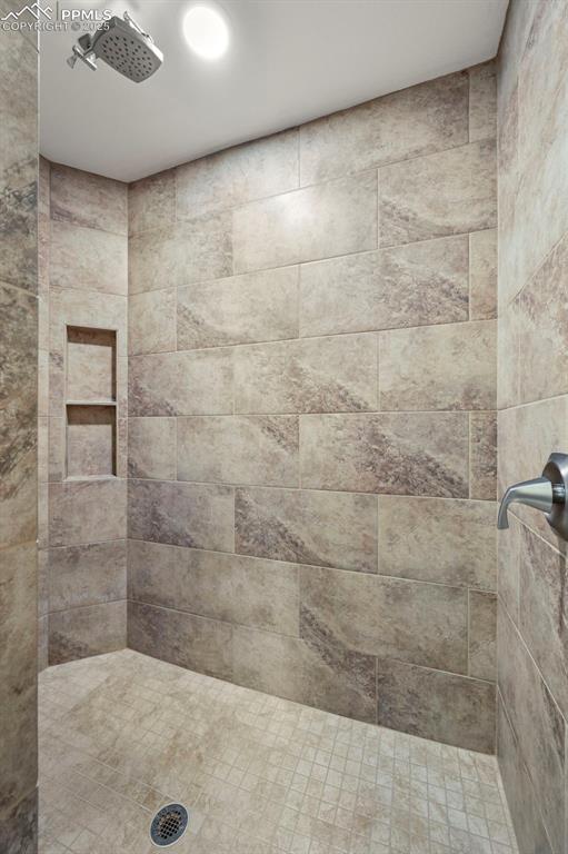 Image 30 of 50: Full bathroom with tiled shower