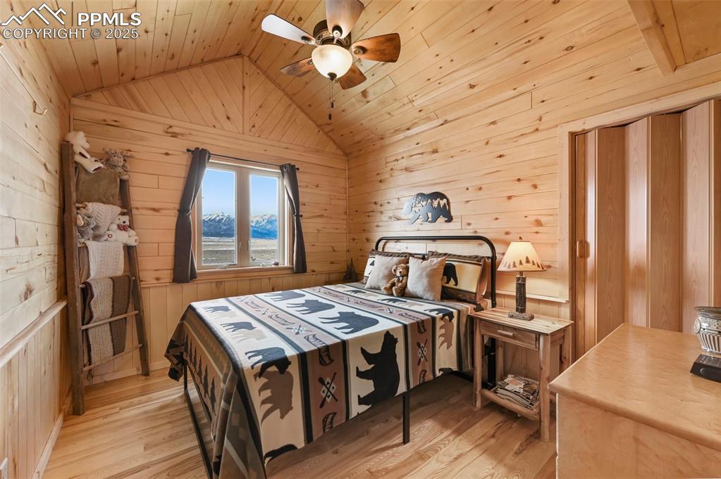 Image 37 of 50: Bedroom featuring lofted ceiling, light wood-style floors, and wood ceiling