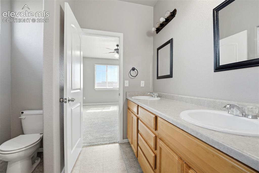 Image 20 of 31: Dual sink vanity with light wood cabinetry, laminate countertop, and indivi
