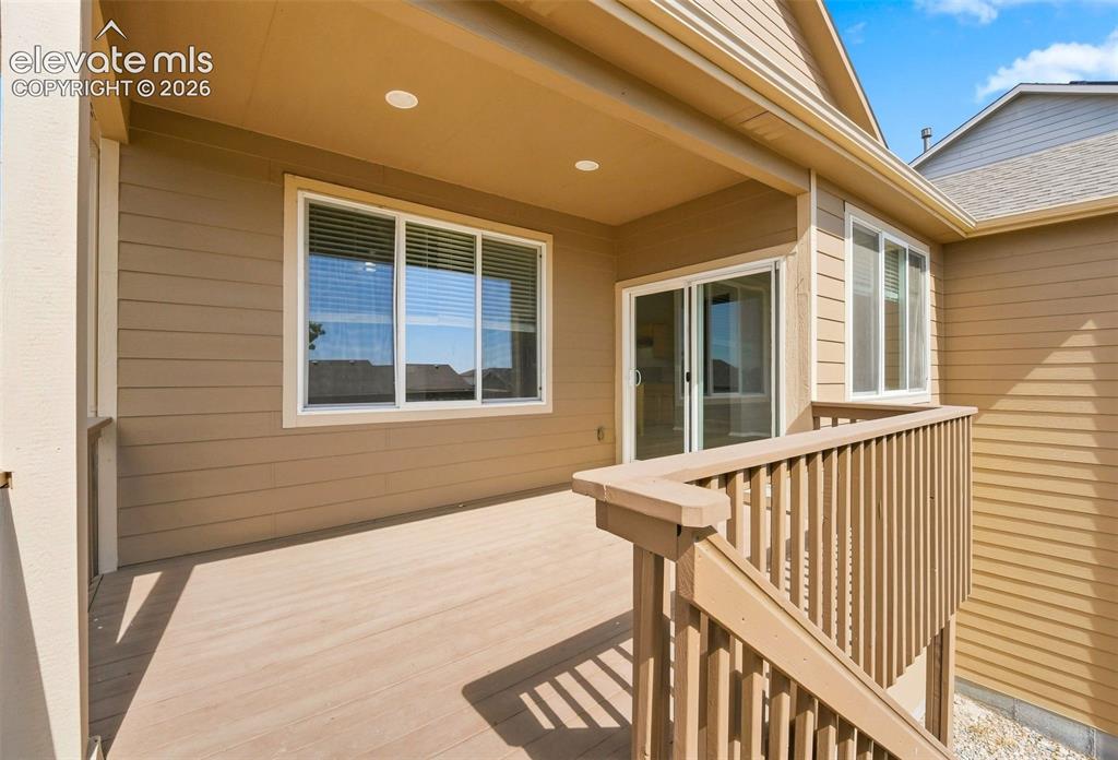 Image 26 of 31: Covered deck featuring composite decking and recessed lighting